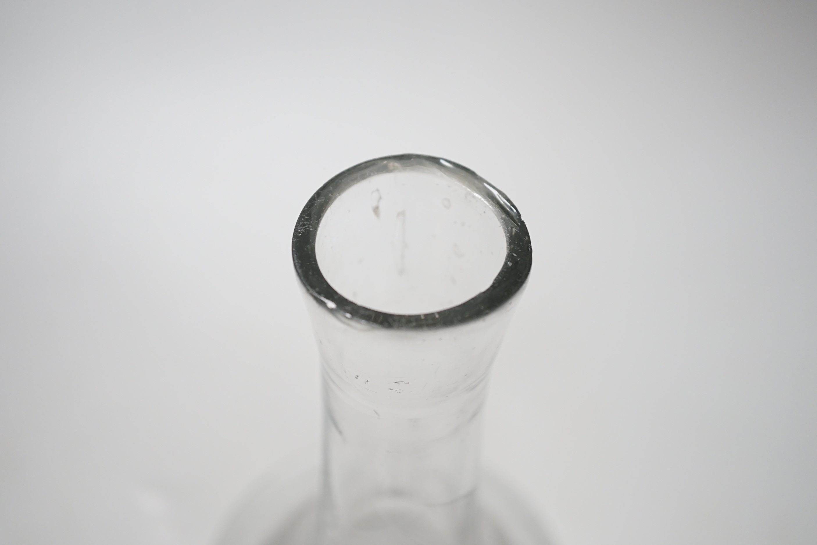 An early 18th century English lead crystal serving bottle, of long shaft and globe in the form of a bell, 23.5cm high
